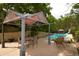 Inviting outdoor living space with pergola, dining table, and lounge chairs, overlooking the pool at 8130 E Bethany Pl, Denver, CO 80231