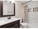 Renovated bathroom boasts modern vanity, shower over tub with elegant tile, and recessed shelving at 13225 Peacock Dr, Lone Tree, CO 80124