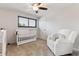 Cozy Bedroom features plush carpet, modern ceiling fan, and serene window view at 13225 Peacock Dr, Lone Tree, CO 80124
