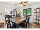 Inviting dining area adjacent to kitchen, featuring stylish lighting, dark furniture, and a dark frame window at 13225 Peacock Dr, Lone Tree, CO 80124