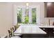 Bright kitchen nook with white countertops and a view to the backyard at 13225 Peacock Dr, Lone Tree, CO 80124