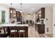 Modern kitchen featuring dark wood cabinets, stainless steel appliances, quartz countertop, and a breakfast bar at 13225 Peacock Dr, Lone Tree, CO 80124