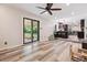 Open concept living room with access to the kitchen and sliding glass doors to backyard at 13225 Peacock Dr, Lone Tree, CO 80124