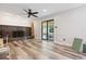 Cozy living room with fireplace, ceiling fan and sliding glass doors to the backyard at 13225 Peacock Dr, Lone Tree, CO 80124