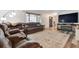 Comfortable living room with plush seating, wood floors, an area rug, and an entertainment center at 13225 Peacock Dr, Lone Tree, CO 80124