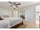 Bright main bedroom featuring a ceiling fan, carpet, and an ensuite bathroom at 13225 Peacock Dr, Lone Tree, CO 80124