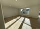 Sunlit living room with hardwood floors and large windows at 5604 Wisteria Ave, Firestone, CO 80504