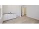 Small wet bar with white cabinets and gray countertop at 5604 Wisteria Ave, Firestone, CO 80504