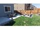 A backyard with patio and lounging furniture, grass, concrete slabs and fenced perimeter at 12828 Fox Ct, Westminster, CO 80234