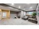 Spacious basement with home theater setup, a sectional couch, and a cozy dog bed at 12828 Fox Ct, Westminster, CO 80234