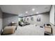 Finished basement features a large grey sectional, large screen television, and movie posters at 12828 Fox Ct, Westminster, CO 80234