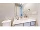 Bathroom featuring a toilet, sink, vanity and large mirror with a view of another bathroom at 12828 Fox Ct, Westminster, CO 80234