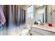 Charming bathroom features a galaxy shower curtain, toilet, sink, and window bringing in light at 12828 Fox Ct, Westminster, CO 80234