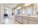 Luxurious bathroom featuring double sinks, a soaking tub, and a walk-in closet at 12828 Fox Ct, Westminster, CO 80234
