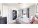 Cozy bedroom features a bookcase, large window with curtains, and a comfy floral bedspread at 12828 Fox Ct, Westminster, CO 80234