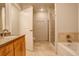 Clean bathroom with a bathtub, shower, and double vanity at 2200 S University Blvd # 201, Denver, CO 80210