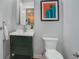 Small bathroom with a green vanity and white toilet at 2200 S University Blvd # 201, Denver, CO 80210