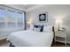 Bright bedroom with large bed, nightstands, and window at 2200 S University Blvd # 201, Denver, CO 80210