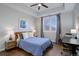 Bedroom with a full-size bed, desk, and hardwood floors at 2200 S University Blvd # 201, Denver, CO 80210