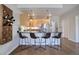 Modern kitchen with breakfast bar and wood cabinets at 2200 S University Blvd # 201, Denver, CO 80210