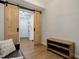 Open living area with barn doors and wood flooring at 2200 S University Blvd # 201, Denver, CO 80210