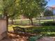 Relaxing backyard featuring a bench, fence, grass, and mature trees at 2105 Keota Ln, Superior, CO 80027