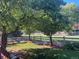Beautiful backyard featuring mature trees providing ample shade and a well-maintained lawn with white fencing at 2105 Keota Ln, Superior, CO 80027