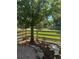 Landscaped backyard featuring a well-kept lawn, a tree, a rock border, and a white picket fence at 2105 Keota Ln, Superior, CO 80027