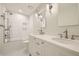 Bathroom with double sink vanity, tile floor, and tiled shower and tub at 2105 Keota Ln, Superior, CO 80027