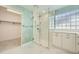 Modern bathroom with a glass-enclosed shower, tile flooring, and a walk-in closet at 2105 Keota Ln, Superior, CO 80027