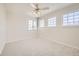 Neutral bedroom with carpet, lighted ceiling fan, and three windows providing plenty of natural light at 2105 Keota Ln, Superior, CO 80027