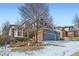 Charming two-story home with a three-car garage and beautiful rock landscaping with snow at 2105 Keota Ln, Superior, CO 80027
