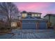 Charming two-story home with a three-car garage and a beautiful blue exterior at dusk at 2105 Keota Ln, Superior, CO 80027