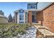 Welcoming front entrance with brick accents, a bay window, and well-maintained landscaping at 2105 Keota Ln, Superior, CO 80027