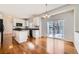 Bright kitchen with island, black appliances, white cabinets, slider door to deck and eat-in area at 2105 Keota Ln, Superior, CO 80027