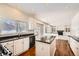 Bright kitchen with island, black appliances, white cabinets and eat-in area at 2105 Keota Ln, Superior, CO 80027
