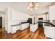 Bright kitchen features white cabinetry, black countertops, and hardwood flooring at 2105 Keota Ln, Superior, CO 80027