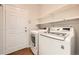 Bright laundry room featuring a washer, dryer, shelves and a door at 2105 Keota Ln, Superior, CO 80027