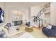 Open-concept living room with hardwood floors, staircase, and dining area with archway at 2105 Keota Ln, Superior, CO 80027