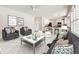 Bright living room with modern decor, opening to a kitchen with white cabinets and bar seating at 2105 Keota Ln, Superior, CO 80027