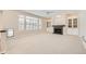 Spacious carpeted living room with fireplace, built-in cabinets, and large windows at 2105 Keota Ln, Superior, CO 80027
