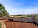 Landscaped backyard featuring a retaining wall, mulch beds, and lush greenery with expansive views at 7292 Firethorn, Littleton, CO 80125