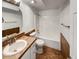 A full bathroom offers tile floors, a tiled vanity, and a shower-tub combo at 7292 Firethorn, Littleton, CO 80125