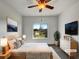 Bright, staged bedroom with large windows and contemporary decor at 7292 Firethorn, Littleton, CO 80125