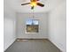 Bright bedroom with neutral carpet, ceiling fan, and a window with expansive outdoor views at 7292 Firethorn, Littleton, CO 80125