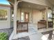 Covered front porch with brick facade and detailed wood features at 7292 Firethorn, Littleton, CO 80125