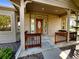 Charming home with covered front porch, wood trim, brick facade, and mature shrubs at 7292 Firethorn, Littleton, CO 80125