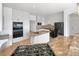 Updated kitchen featuring granite countertops, stainless steel appliances, and a center island with a sink at 7292 Firethorn, Littleton, CO 80125