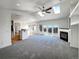 Open living room with fireplace, skylights, and deck access through large glass doors at 7292 Firethorn, Littleton, CO 80125