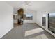 Bright living room with fireplace and large windows offering natural light and a view of the backyard at 7292 Firethorn, Littleton, CO 80125